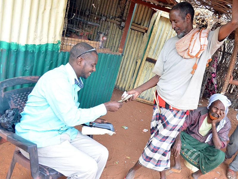 Abdi Mohammed an agent paying the new HSNP cash value of Kshs. 5,100 in Wagalla, Wajir