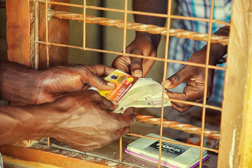 A beneficiary receiving HSNP cash transfer payment from an agent